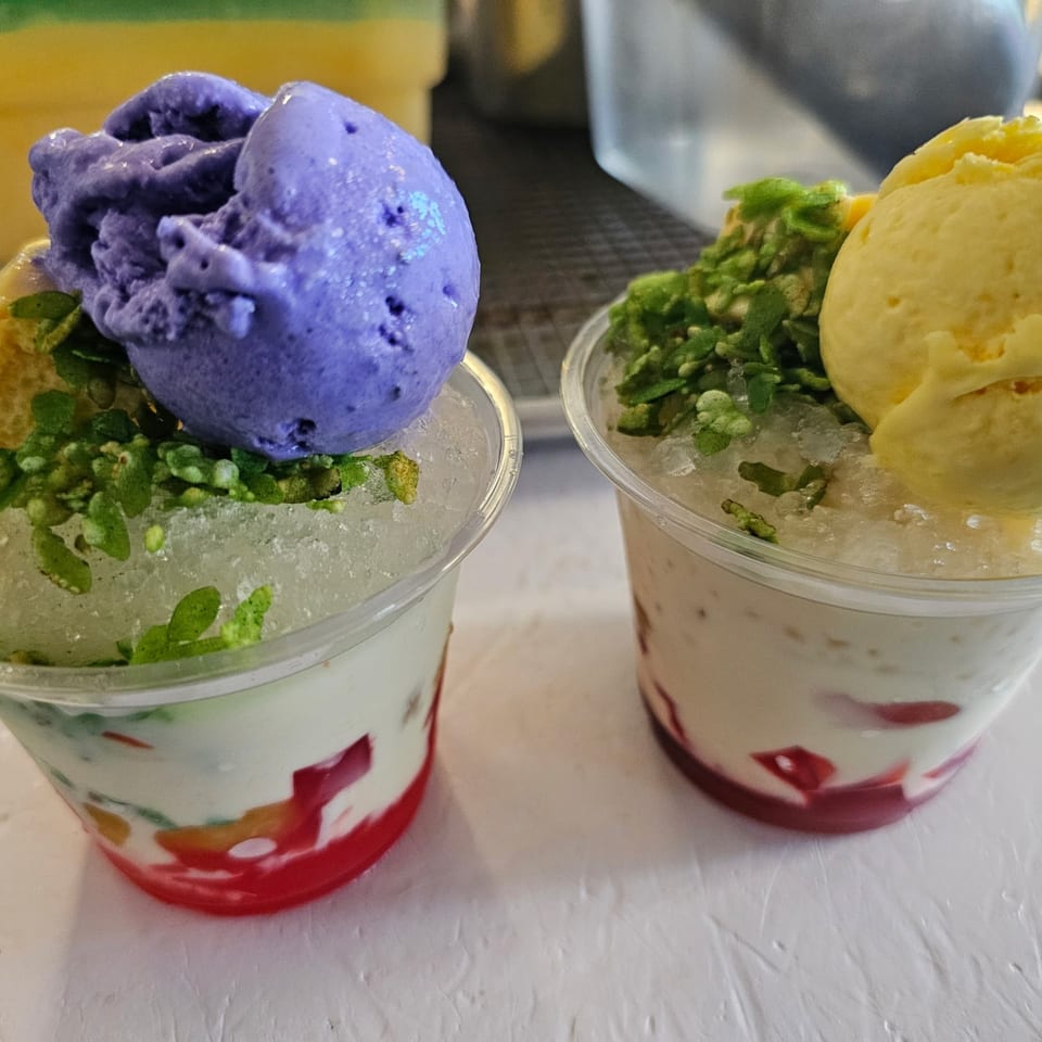 Two Kujo Eats halo-halo desserts with ube and mango ice cream, green toppings, and red jelly.